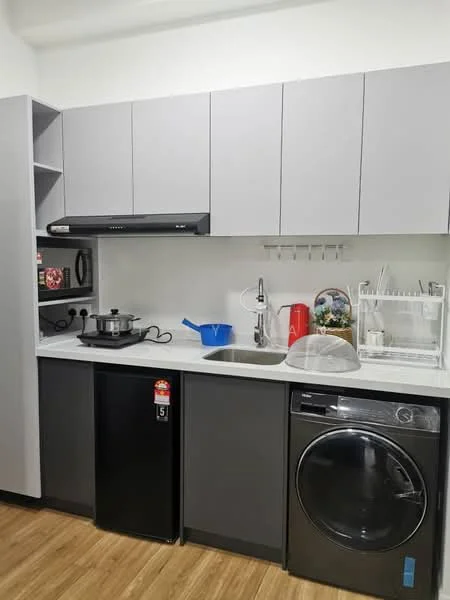 Kitchen features: grey cabinetry, white countertop, single-bowl stainless-steel sink, chrome pull-down faucet, built-in oven, microwave, black fridge, front-load washing machine, dish rack, kitchen utensils, blue plastic container, cooking pot; style: modern.