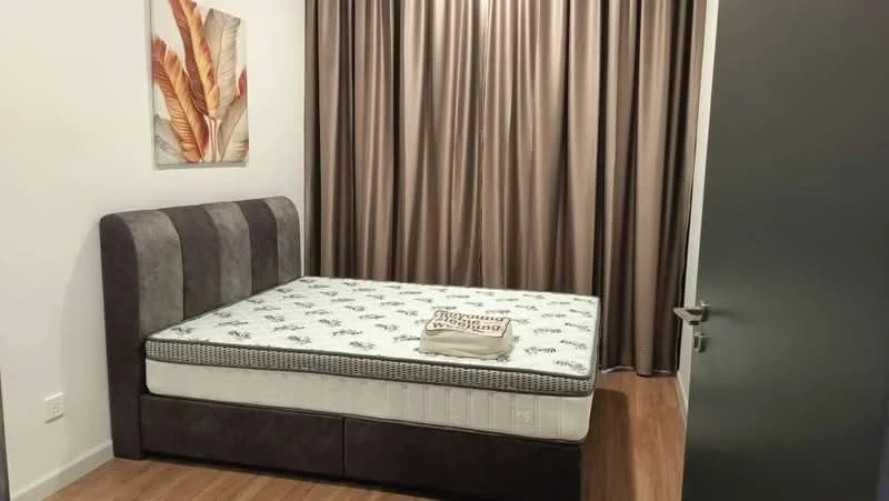 Bedroom features: queen-size bed with upholstered headboard, mattress with patterned cover, brown curtains, wooden flooring, decorative wall art with leaf design, built-in wardrobe, nightstand with decorative item; style: modern.