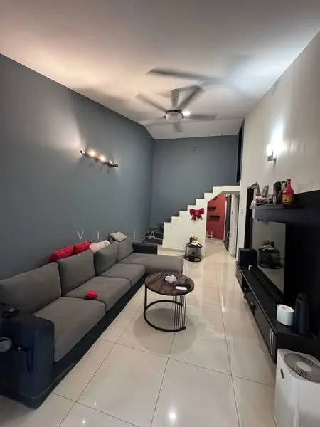 Living features: grey painted walls, white ceiling, 5-blade ceiling fan, recessed downlights, large sectional sofa in grey, round coffee table, TV console, wall-mounted TV, polished tile flooring, staircase with white railing, decorative wall art, shelves with decorative items; style: modern.