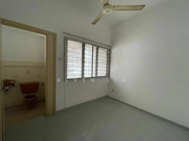 Room features: white painted walls, grey flooring, ceiling fan, window with horizontal slats, doorway leading to bathroom, natural light from window, no visible furniture, minimalist decor; style: minimalist.