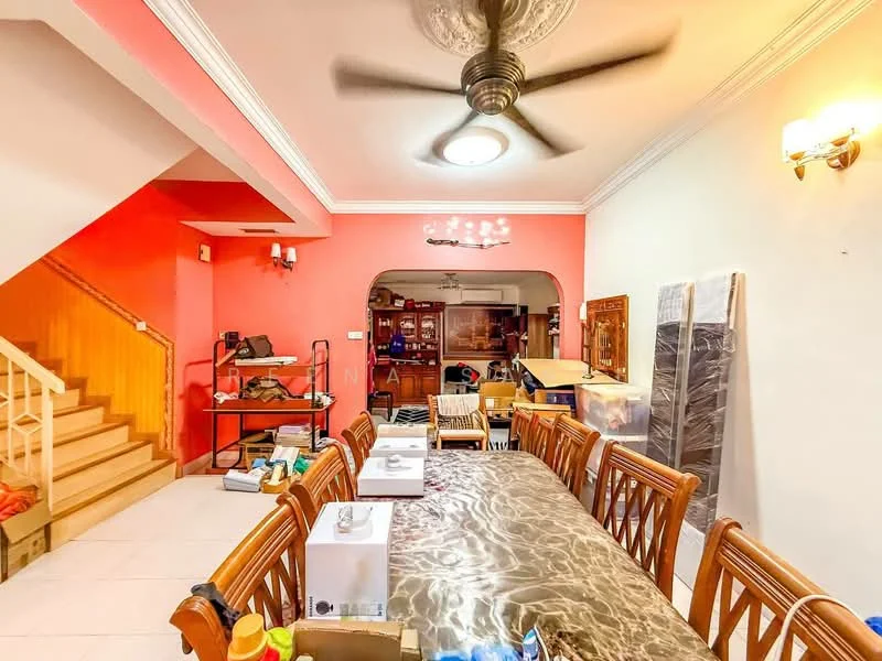 Dining features: large dining table with patterned tablecloth, wooden dining chairs, ceiling fan with light, pink accent wall, white painted walls, recessed ceiling lights, tile flooring, decorative wall sconces, staircase in background, open kitchen area visible, cluttered storage in background; style: modern.