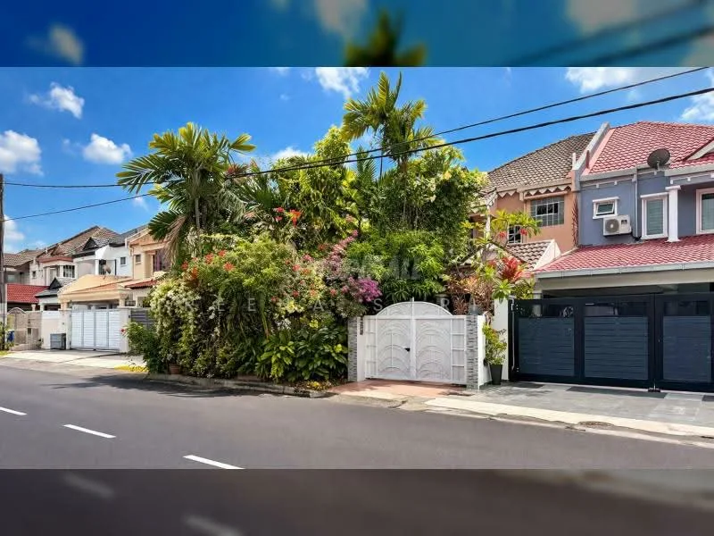 Exterior type: linked terrace house; features: white painted facade, red tiled roof, manicured garden with tropical plants, palm trees, stone-paved walkway, double-volume main entrance gate, driveway with interlocking pavers, visible car porch, surrounded by mature greenery; style: modern.