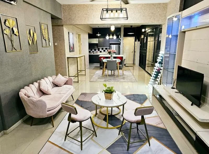 Living features: pink velvet 3-seater sofa, round coffee table with gold base, 2 dining chairs with grey upholstery, area rug with geometric pattern, wall-mounted TV, white entertainment unit, decorative wall art with floral motifs, recessed ceiling lights, pendant light fixture, open-plan layout to dining area, cream painted walls, glossy tile flooring; style: modern. Dining features: 6-seater dining table, grey upholstered dining chairs, decorative centerpiece with flowers, open kitchen layout, kitchen island visible in background; style: modern.