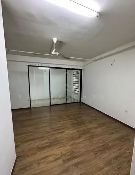 Room features: laminate flooring, white painted walls, exposed ceiling with fluorescent lights, 5-blade ceiling fan, glass sliding door, window with grille, corner wall with ventilation blocks; style: modern.