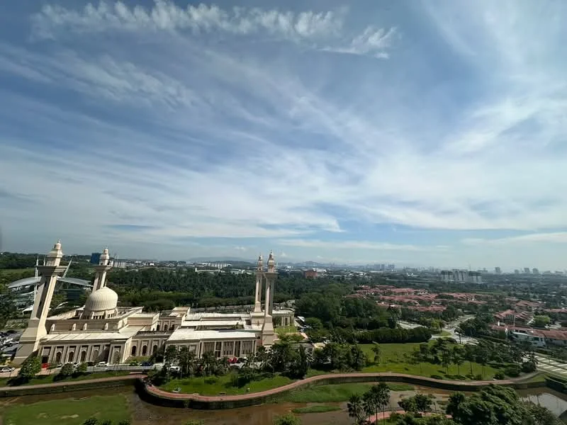 Exterior features: city skyline view, manicured landscaping, large green area, prominent architectural structure, multiple towers, domed roof, surrounding greenery, urban context; style: modern.