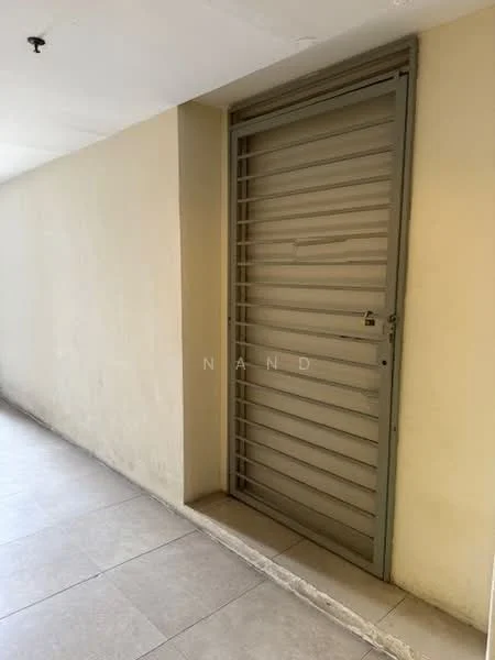Room features: grey metal door with horizontal slats, cream painted walls, light grey tiled flooring, door frame with lock, no visible windows or additional features.