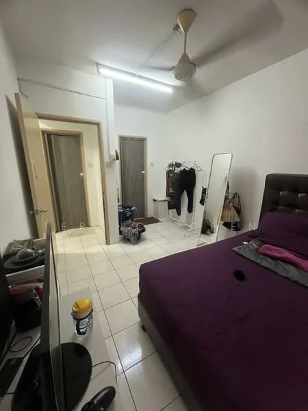Bedroom features: purple bedspread, queen-size bed, upholstered headboard, floor-mounted mirror, wall-mounted TV, white painted walls, ceiling fan, tile flooring, clothes rack, two doors leading to other rooms, decorative items on TV stand.