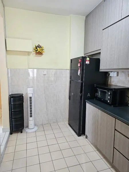 Kitchen features: black fridge, microwave, grey cabinetry, black countertop, white tiled backsplash, cream painted walls, tile flooring, standing fan, decorative wall flower arrangement; style: modern.