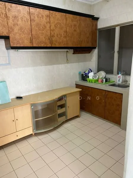 Kitchen features: wood cabinetry with brown finish, white tiled walls, light-colored countertop, stainless-steel sink, single-bowl sink, window above sink, dish rack, kitchen utensils on countertop, ceramic tile flooring, built-in cabinet with glass door, open shelving, kitchen appliances visible.