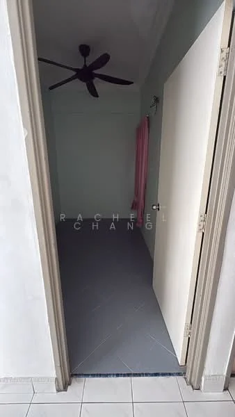 Room features: grey tiled flooring, white painted walls, sloped ceiling, ceiling fan, door with handle, curtain rod, pink curtain, light switch.
