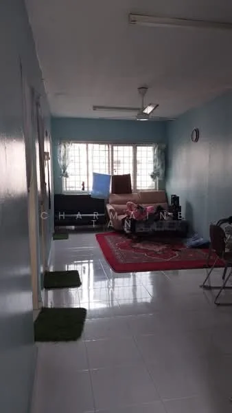 Living features: light blue painted walls, white tiled flooring, 5-blade ceiling fan, large window with sheer curtains, sofa, coffee table, area rug with geometric pattern, wall clock, decorative plants, TV console, freestanding TV cabinet.