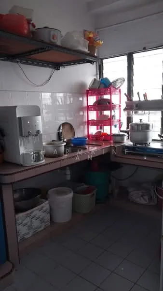 Kitchen features: L-shaped countertop, stainless-steel sink, water dispenser, open shelving, plastic storage containers, dish rack with dishes, cooking pots, tile flooring, window with natural light, white tiled walls.