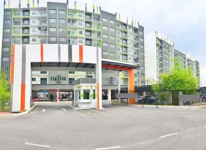 Exterior type: mid-rise condominium; features: multi-storey building, covered parking area, main entrance gate, security guard house, landscaped greenery, driveway with interlocking pavers, colorful facade with orange and green accents, visible parking spaces; style: modern.