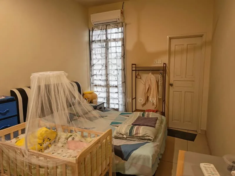 Bedroom features: cream painted walls, tile flooring, 1 wall-mounted split AC, single bed with bedding, crib with yellow bedding, wardrobe with sliding doors, window with sheer curtains, clothes rack, decorative bedspread, bedside items on bed.