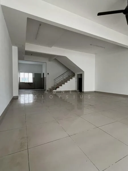 Room features: white painted walls, polished ceramic tile flooring, exposed ceiling with lighting fixtures, staircase leading to upper floor, large window for natural light, open layout, ceiling fan, no visible furniture or decor; style: modern.