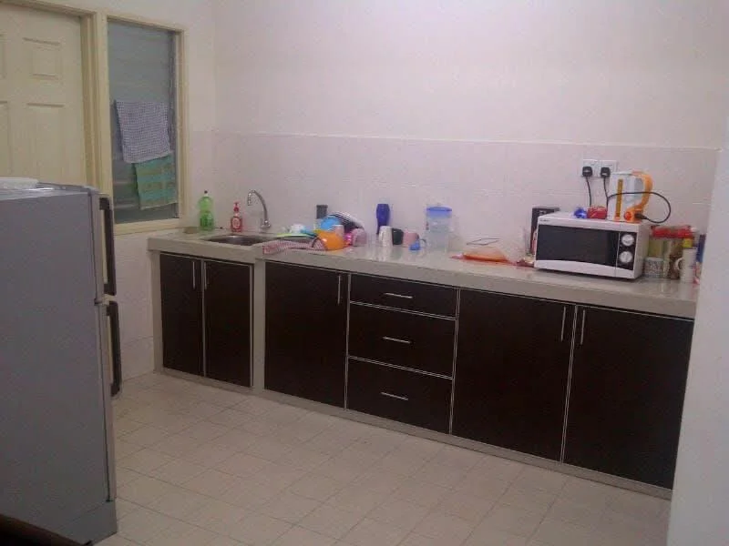Kitchen features: stainless-steel sink, chrome pull-down faucet, laminate countertop, dark wood cabinetry, built-in microwave, freestanding fridge, ceramic tile flooring, wall-mounted electrical outlets, various kitchen utensils and containers, window with sheer curtains; style: modern.