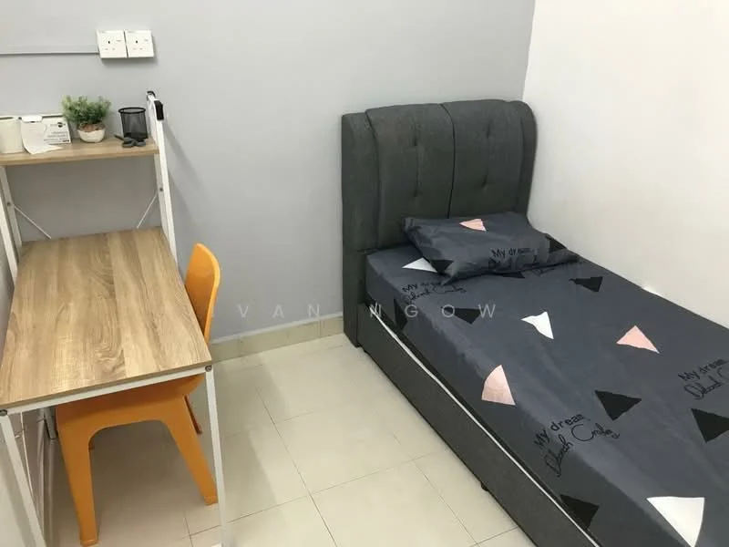 Bedroom features: single bed with grey upholstered headboard, bedding with geometric pattern, wooden desk, orange plastic chair, small potted plant, white walls, tile flooring, power outlets on the wall; style: modern.