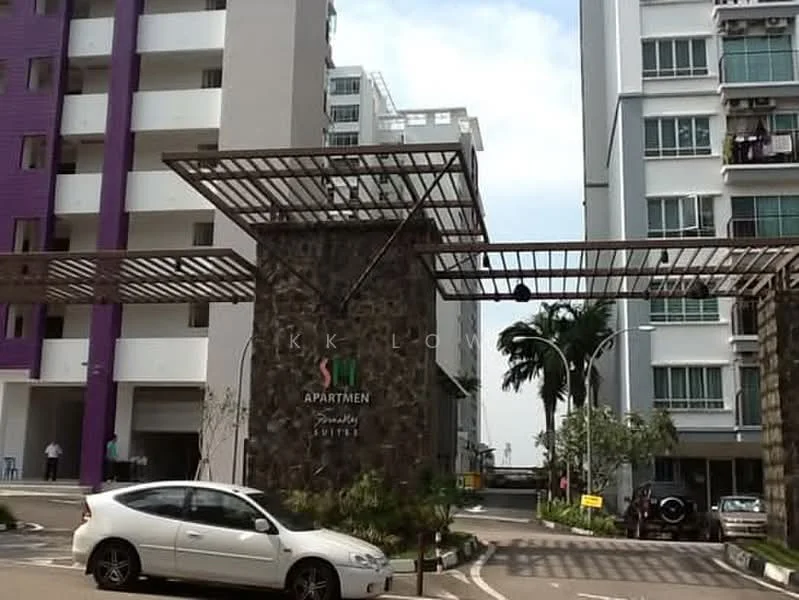 Exterior type: low-rise apartment block; features: stone cladding at entrance, metal canopy over entrance, landscaped greenery, manicured lawn, parking area, surrounding residential buildings, driveway with interlocking pavers; style: modern.