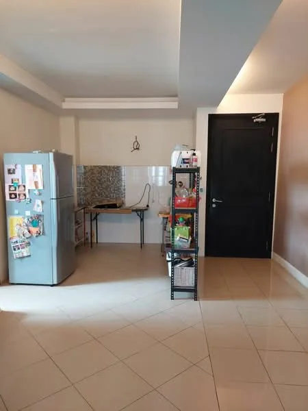 Kitchen features: light grey painted walls, cream tiled flooring, white backsplash with mosaic pattern, black metal shelving unit, table with black legs, stainless-steel fridge, black door, ceiling with recessed lighting; style: modern.