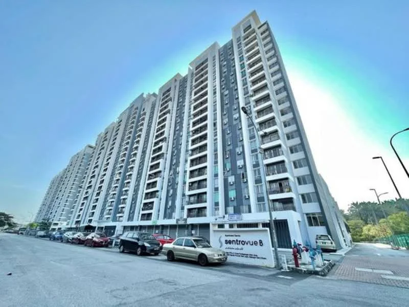 Exterior type: mid-rise condominium; features: white painted facade, balconies on each floor, glass windows, parking spaces visible, surrounded by greenery, multiple storeys, street view, signage at entrance; style: modern.