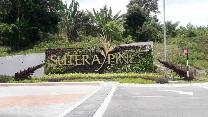 Exterior features: landscaped entrance, signage with 'Sutera Pines', greenery surrounding entrance, paved driveway, decorative plants, roadside sign, curved pathway, stone wall feature; style: modern.
