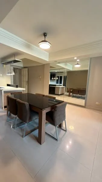 Dining features: glass-top dining table, 4 upholstered dining chairs, pendant light fixture, mirrored wall, neutral painted walls, tile flooring, recessed lighting, open layout to kitchen; style: modern.