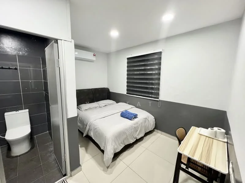 Bedroom features: queen-size bed with grey upholstered headboard, white bedding, 2 blue towels on bed, wall-mounted air conditioning unit, sliding window with black-out blinds, light grey painted walls, white ceiling with recessed lighting, tile flooring, small wooden table, woven chair, en-suite bathroom with glass shower enclosure, toilet in bathroom; style: modern.