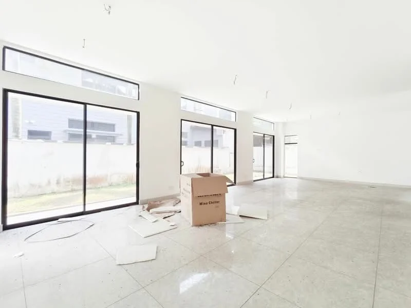 Room features: white painted walls, polished tile flooring, floor-to-ceiling windows, sliding glass doors, natural light from multiple windows, open layout, unfinished space with construction debris, concrete ceiling with exposed fixtures; style: modern; view: garden.