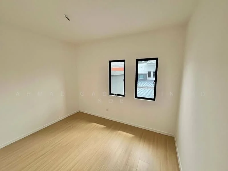 Room features: light wood laminate flooring, white painted walls, two casement windows, natural light from windows, no visible ceiling features, no visible furniture or decor; style: minimalist.