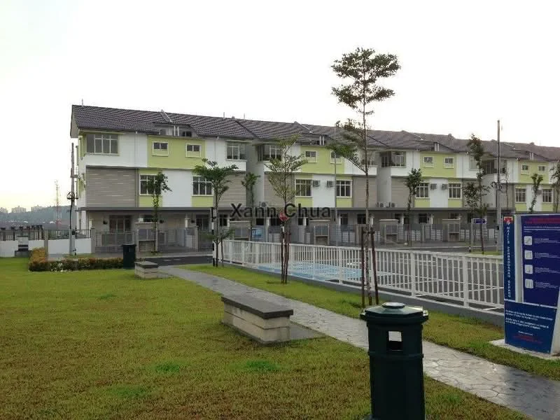Exterior type: linked terrace house; features: two-storey linked terrace houses, green painted facade, grey cladding, pitched tile roof, manicured lawn, stone-paved walkway, perimeter fence, swimming pool visible in background, mature trees, outdoor lighting, parking area; style: modern.