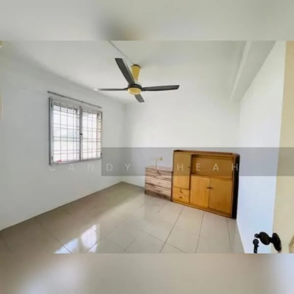 Room features: white painted walls, tiled flooring, ceiling fan, window with grille, wooden cabinet, natural light from window.