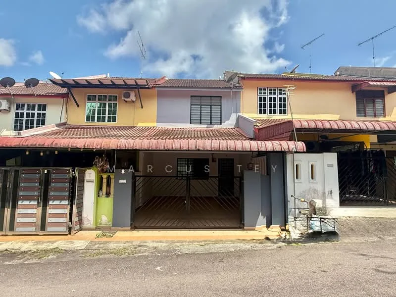 Exterior type: linked terrace house; features: two-storey building, yellow and grey painted facade, red tiled roof, front porch area, multiple windows, metal gate, mailbox units, visible antennae on roof, paved walkway, surrounding greenery; style: modern.