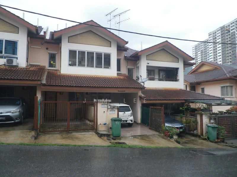 Exterior type: linked terrace house; features: two-storey building, red tiled roof, cream painted facade, front porch with car parking, metal gate, visible air conditioning units, manicured front garden, driveway with interlocking pavers, surrounded by residential area, adjacent to high-rise buildings; style: modern.