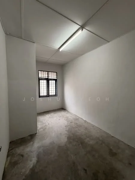 Room features: white painted walls, concrete flooring, single window with grid pattern, fluorescent ceiling light, plain ceiling, no visible furniture or decor; style: minimalist.