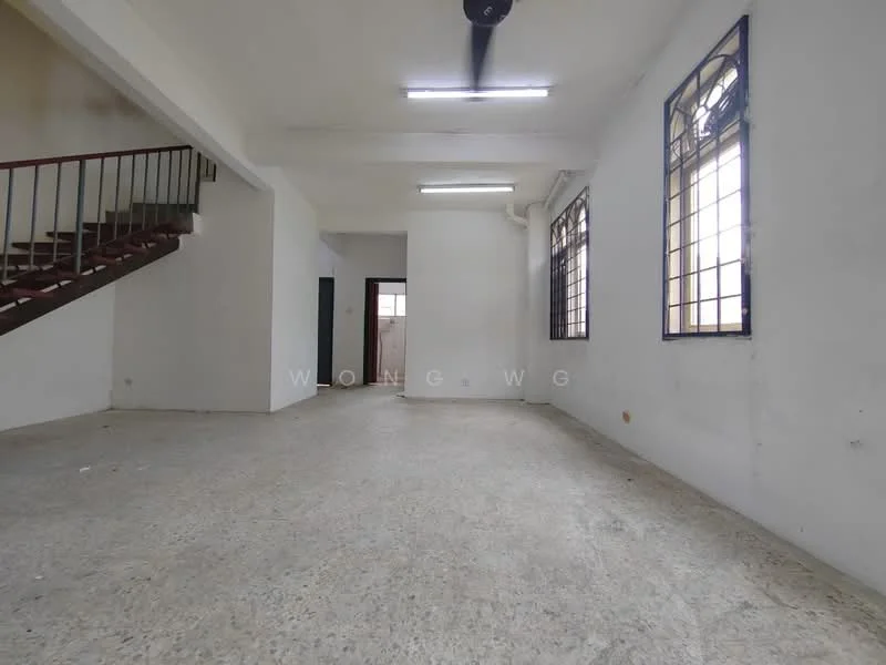Room features: concrete flooring, white painted walls, exposed ceiling with fluorescent lights, large windows with metal frames, staircase with metal railing, open layout, no visible furniture, neutral color scheme; style: minimalist.