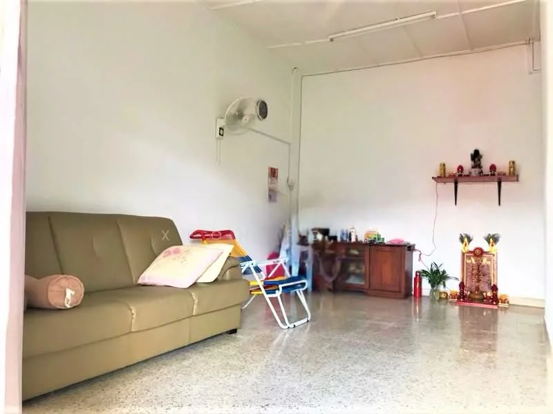Living features: beige fabric sofa, decorative cushions, wall-mounted fan, wooden cabinet, shelf with decorative items, houseplants in pots, polished concrete flooring, white painted walls, natural light from window; style: minimalist.