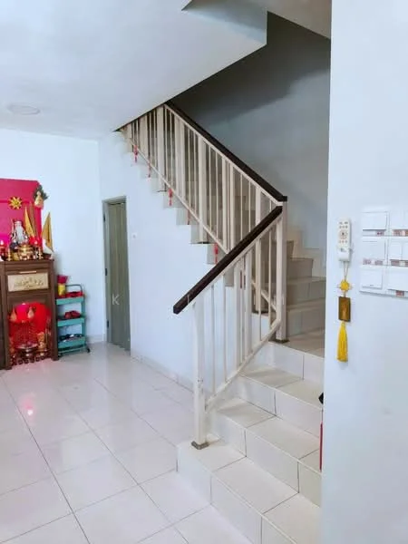 Room features: white painted walls, cream tiled flooring, staircase with white railing, grey accent wall, decorative altar with offerings, small green shelving unit, wall-mounted mailbox, light fixture on ceiling; style: modern.