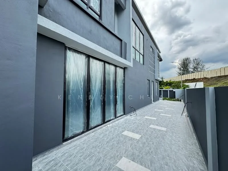Exterior features: grey painted facade, large floor-to-ceiling windows with protective covering, concrete pathway, light grey stone paving, manicured landscaping, retaining wall, sloped garden area; style: modern.