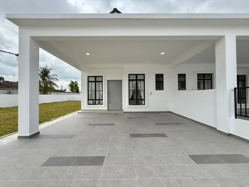 Exterior type: detached bungalow; features: white painted facade, flat roof, grey tiled flooring, large windows with black frames, covered porch area, manicured lawn, surrounded by low white wall, outdoor lighting, paved walkway; style: modern.
