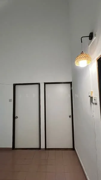 Room features: white painted walls, high ceiling, brown wooden doors, hanging pendant light with woven shade, brown tiled flooring, light switch, door frame, wall-mounted electrical outlet; style: modern.