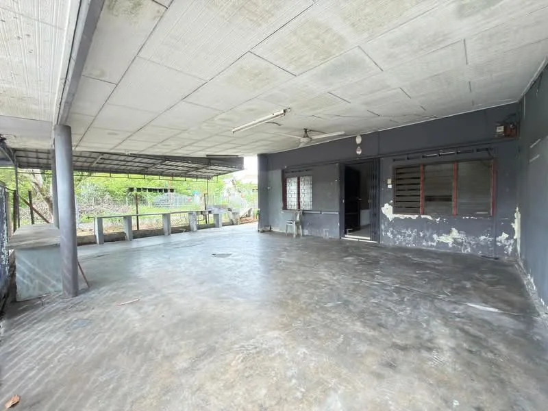 Exterior features: concrete flooring, exposed ceiling, open space, partially covered area, walls with grey paint, large windows, metal support beams, outdoor area with potential for landscaping; style: minimalist.