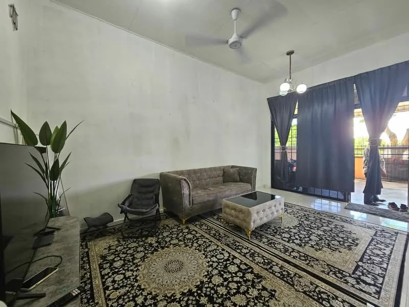 Living features: grey fabric sofa, black and cream area rug with intricate pattern, glass coffee table, TV console, wall-mounted TV, 5-blade ceiling fan, two pendant lights, black curtains, sliding glass door, plant in ceramic pot, exposed concrete walls, tile flooring; style: modern; view: garden.