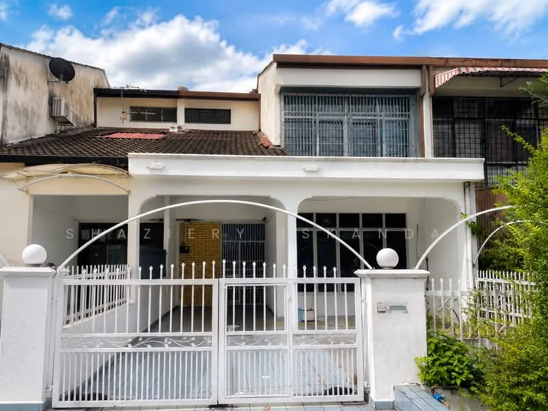 Exterior type: semi-detached house; features: white painted facade, flat roof, single-storey, fenced front yard with gate, paved driveway, mature greenery, window grilles, satellite dish on roof, awnings over windows, brick wall, front porch area; style: modern.