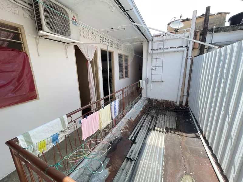 Room features: balcony, metal railing, clothesline, exposed metal roofing, wall-mounted air conditioning unit, window with curtain, tile flooring, partially covered area, metal fence, drainage system.