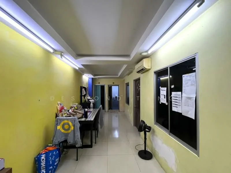 Hallway features: yellow painted walls, glossy tile flooring, recessed ceiling lights, air conditioning unit, multiple doors, windows with paper notices, table with items, decorative wall art, open space layout.