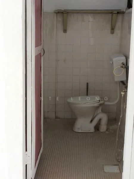 Bathroom features: white tiled walls, white ceramic floor tiles, one-piece toilet, toilet paper holder, sink with faucet, mirror, shelf above sink, door with red panels.