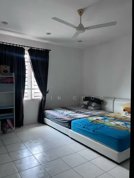Bedroom features: two single beds with colorful bedding, white bed frames, ceiling fan, white painted walls, tiled flooring, black curtains, window with grid pattern, bookshelf with open shelving.
