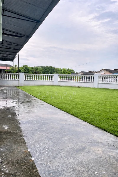 Exterior features: manicured lawn, concrete flooring, white painted fence, covered patio, overcast sky, surrounding greenery; style: modern.