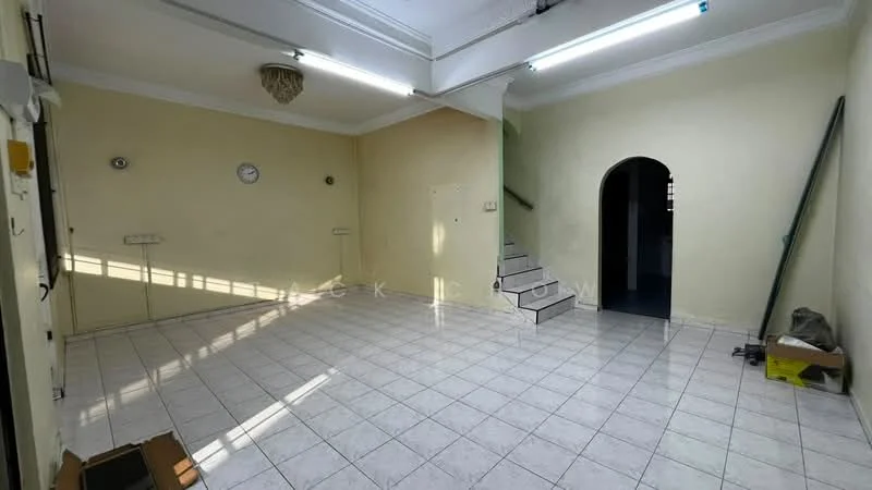 Room features: cream painted walls, white tiled flooring, recessed ceiling lights, wall clock, staircase leading to upper floor, arched doorway, baseboards, no visible furniture.