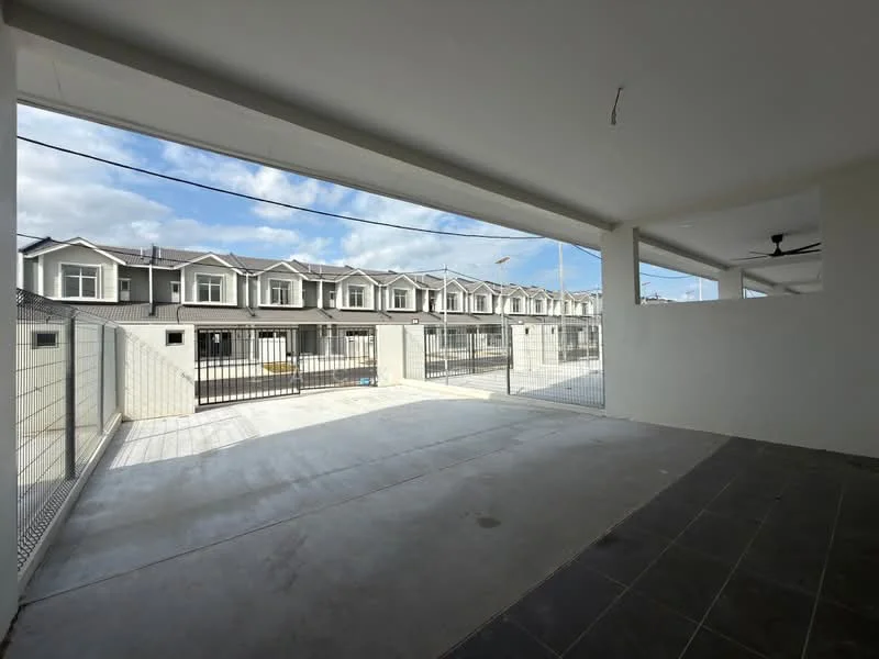 Exterior type: linked terrace house; features: concrete flooring, fenced perimeter, open-air car porch, multiple storey linked houses in background, clear blue sky, natural light from large openings; style: modern.